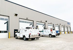 Japa Machinery vehicles parked outside building bay doors