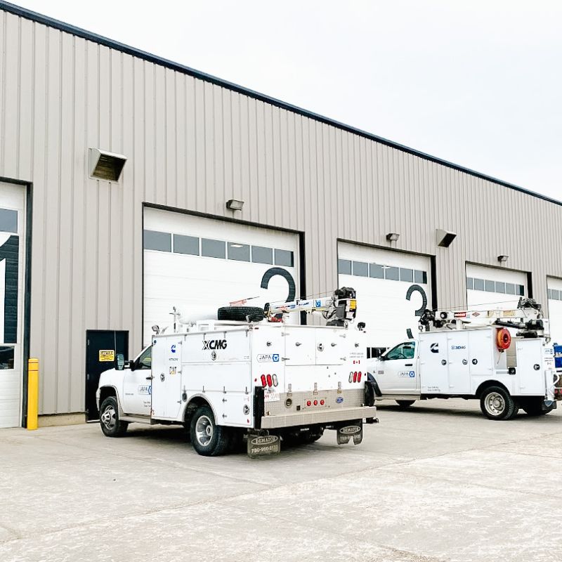 Japa Machinery on-site service trucks parked outside building bay doors